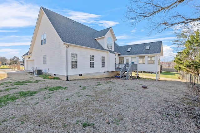 back of property with central AC unit and a wooden deck