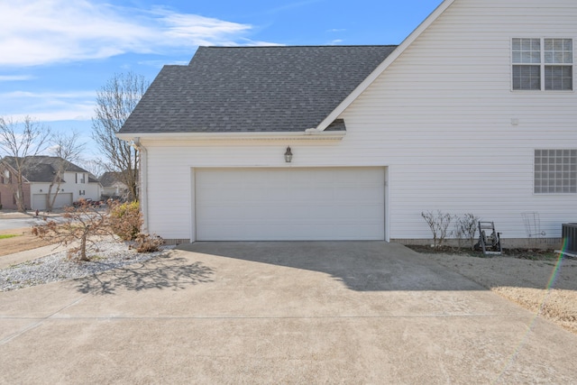 view of property exterior featuring a garage and central AC unit