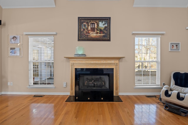 living room with hardwood / wood-style flooring and ornamental molding