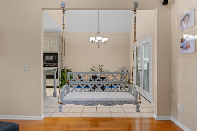 dining area featuring light wood-type flooring and a chandelier