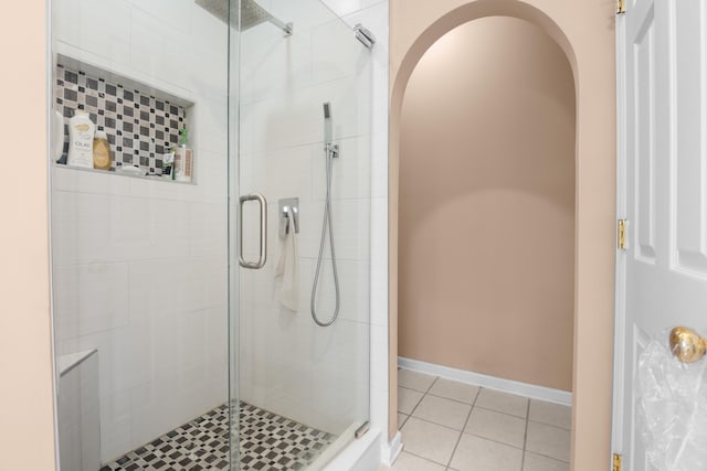 bathroom with tile patterned floors and a shower with shower door