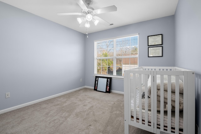 unfurnished bedroom featuring light colored carpet and ceiling fan