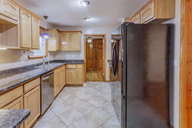 kitchen featuring black refrigerator, hanging light fixtures, stainless steel dishwasher, and light brown cabinets