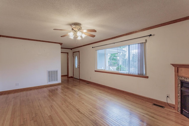 unfurnished living room featuring ceiling fan, crown molding, light hardwood / wood-style flooring, and a textured ceiling