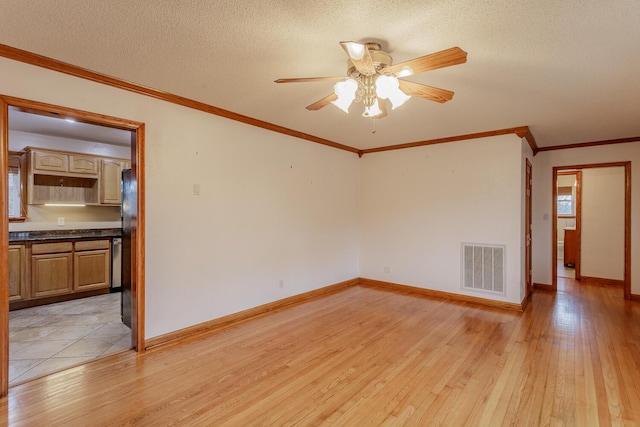 unfurnished room featuring ceiling fan, ornamental molding, light hardwood / wood-style floors, and a textured ceiling