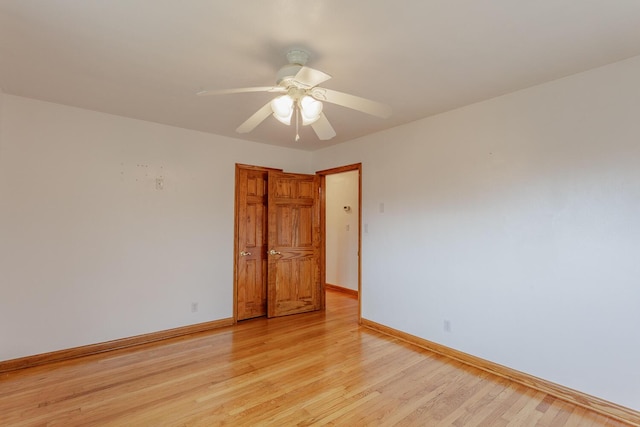 spare room with light hardwood / wood-style flooring and ceiling fan