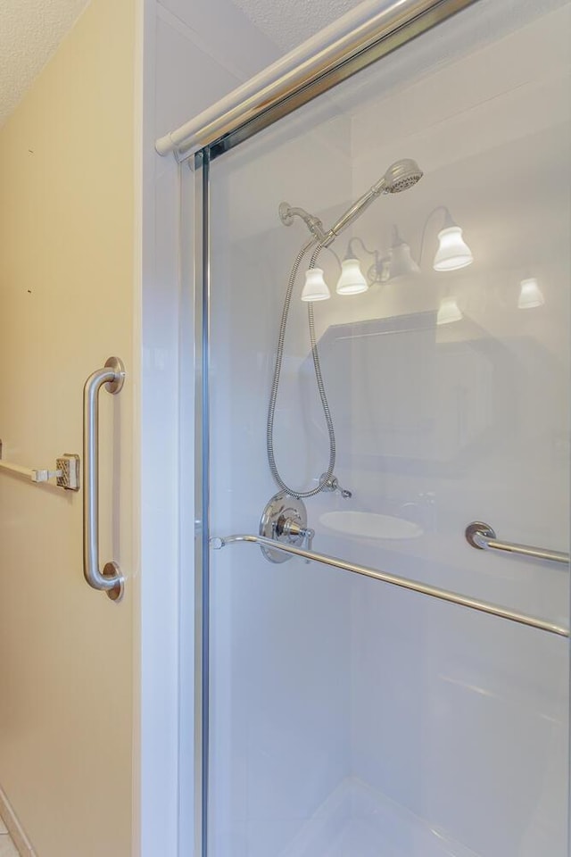 bathroom featuring a textured ceiling and walk in shower