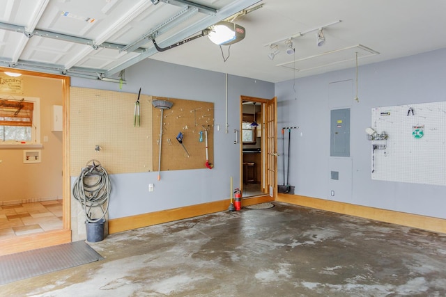 garage featuring a garage door opener, electric panel, and a workshop area