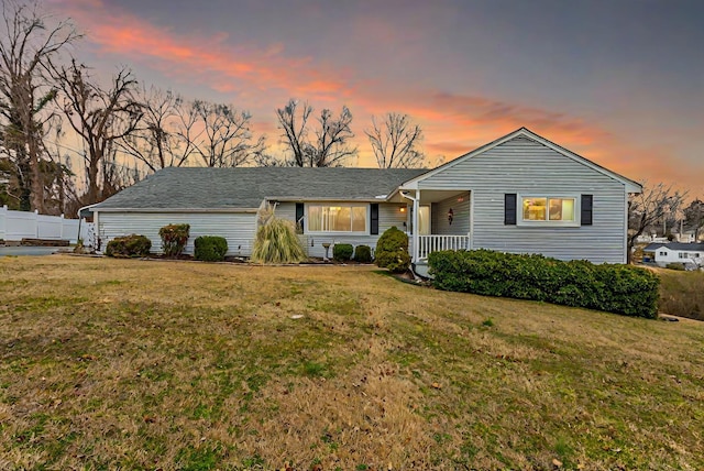 single story home featuring a yard and covered porch