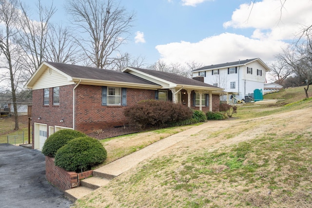 view of front of property with a garage and a front lawn