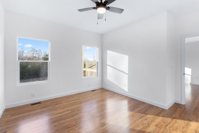 empty room featuring hardwood / wood-style floors and ceiling fan