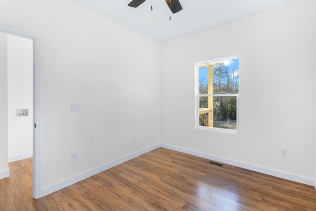 empty room with hardwood / wood-style floors and ceiling fan