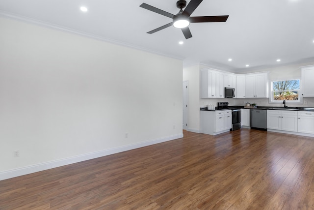 kitchen with crown molding, stainless steel appliances, dark hardwood / wood-style floors, and white cabinets