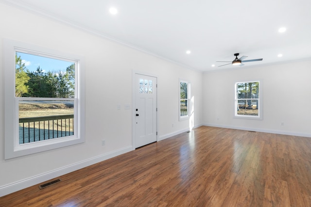 entryway with crown molding, ceiling fan, and dark wood-type flooring