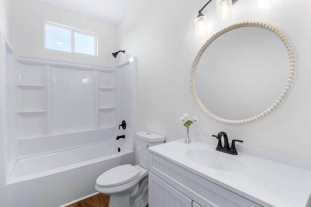 full bathroom with  shower combination, toilet, hardwood / wood-style floors, and vanity