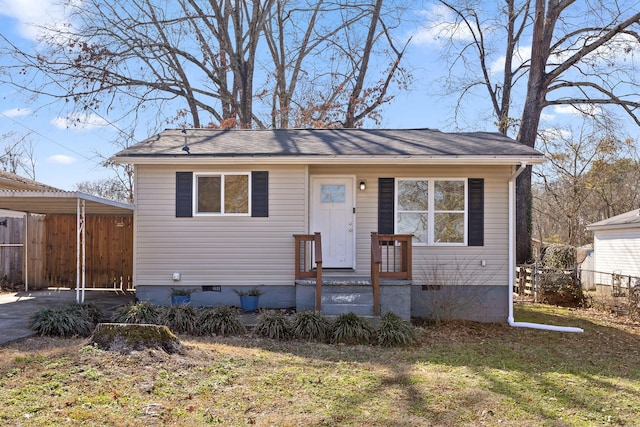 view of front facade with a front yard and a carport