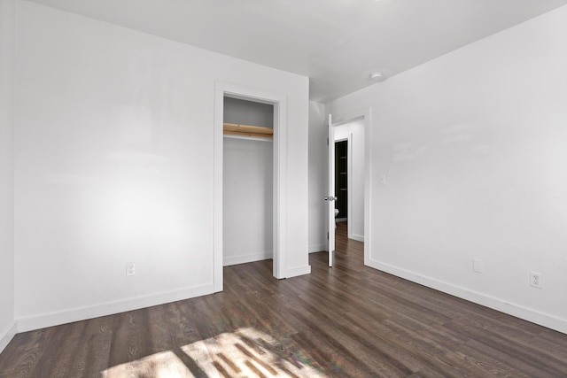 unfurnished bedroom featuring dark hardwood / wood-style floors and a closet