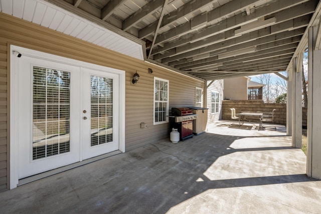 view of patio featuring french doors, grilling area, and fence