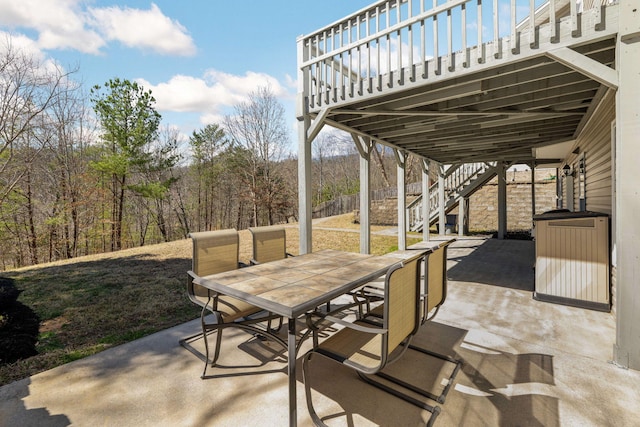 view of patio / terrace featuring outdoor dining space and stairway