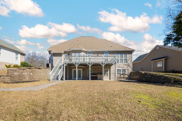 rear view of property with a shingled roof, stairway, a yard, a deck, and french doors