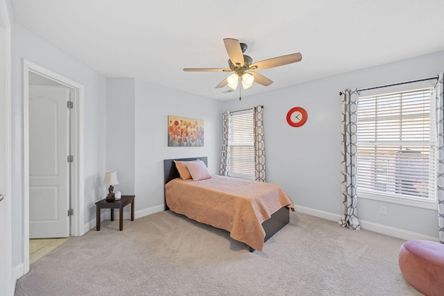 bedroom featuring carpet floors, baseboards, and a ceiling fan