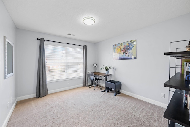 carpeted office with baseboards and visible vents