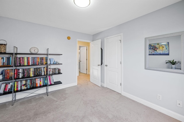 interior space featuring carpet flooring and baseboards