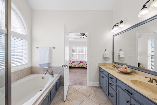 bathroom with double vanity, ensuite bathroom, a sink, and tile patterned floors