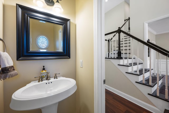 bathroom featuring a sink, baseboards, and wood finished floors