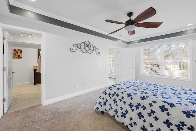 tiled bedroom featuring baseboards, carpet flooring, and crown molding