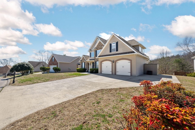 view of front of home featuring driveway, a garage, and a front yard