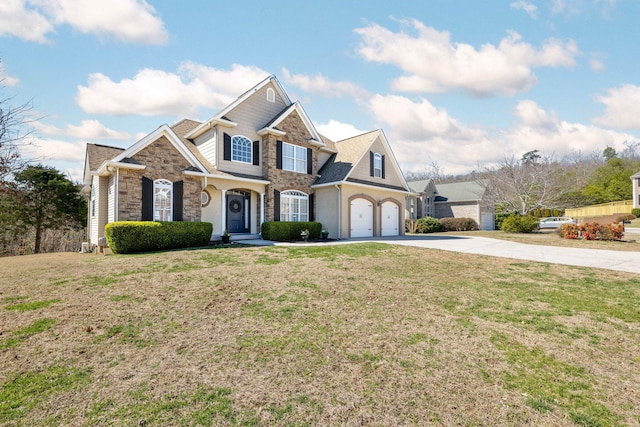 view of front of property featuring a garage, stone siding, driveway, and a front lawn