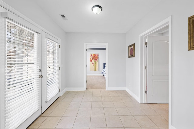 entryway featuring french doors, visible vents, baseboards, and light tile patterned floors