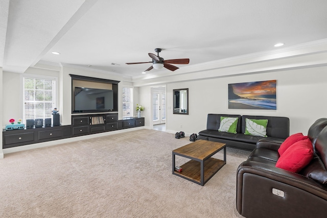 carpeted living area featuring a ceiling fan, baseboards, crown molding, and recessed lighting