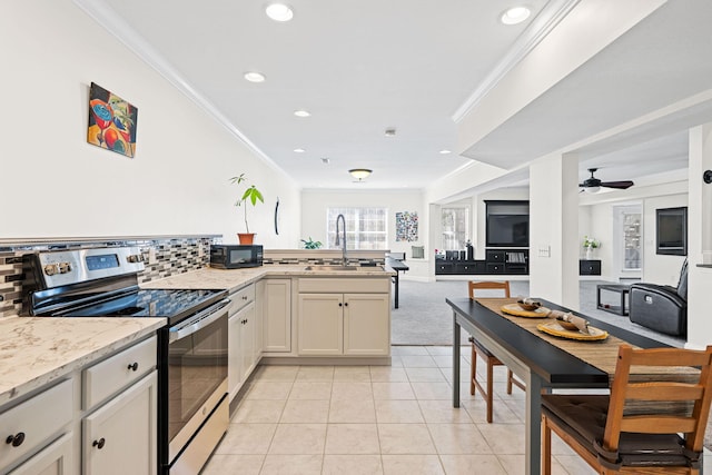 kitchen with black microwave, electric stove, ornamental molding, and a sink