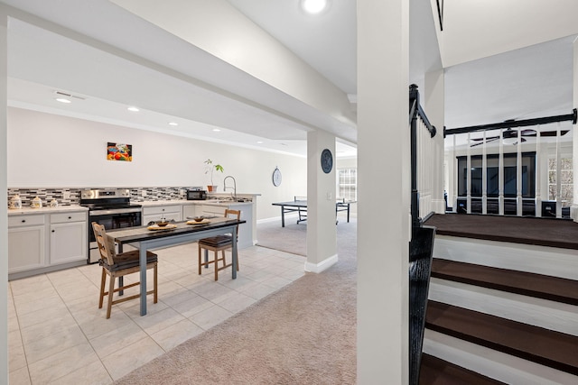 dining area with recessed lighting, light carpet, baseboards, and light tile patterned floors