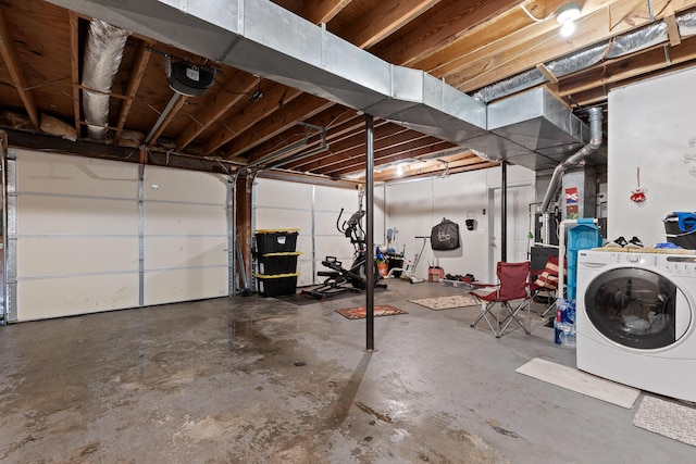 garage with washer / clothes dryer and a garage door opener