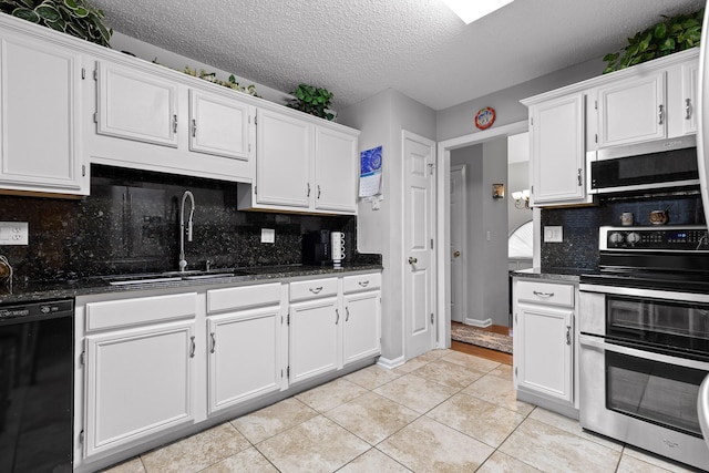 kitchen with stainless steel appliances, sink, and white cabinets