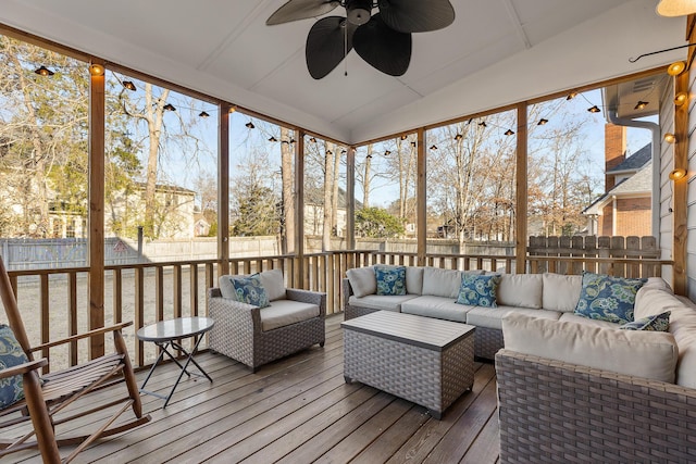 sunroom featuring vaulted ceiling and ceiling fan