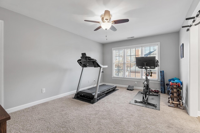 exercise area with ceiling fan and carpet