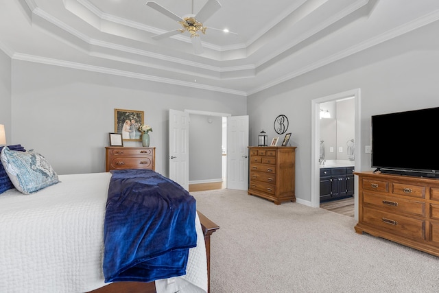 bedroom with ornamental molding, connected bathroom, a raised ceiling, and light carpet