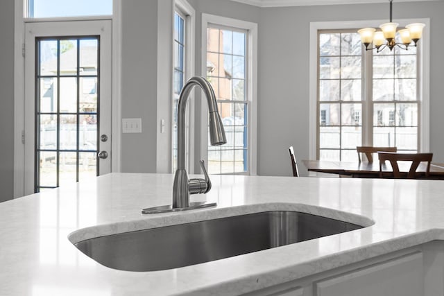 interior space with hanging light fixtures, sink, and a chandelier