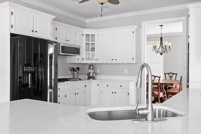 kitchen featuring white cabinetry, sink, crown molding, and appliances with stainless steel finishes