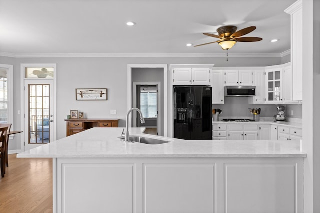 kitchen with white cabinetry, stainless steel appliances, crown molding, and sink