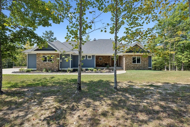 view of front facade featuring stone siding and a front yard