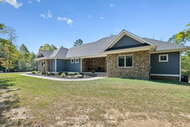 view of front of property featuring central AC and a front yard