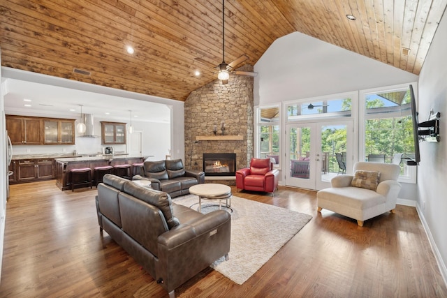 living room featuring hardwood / wood-style flooring, high vaulted ceiling, french doors, and wooden ceiling