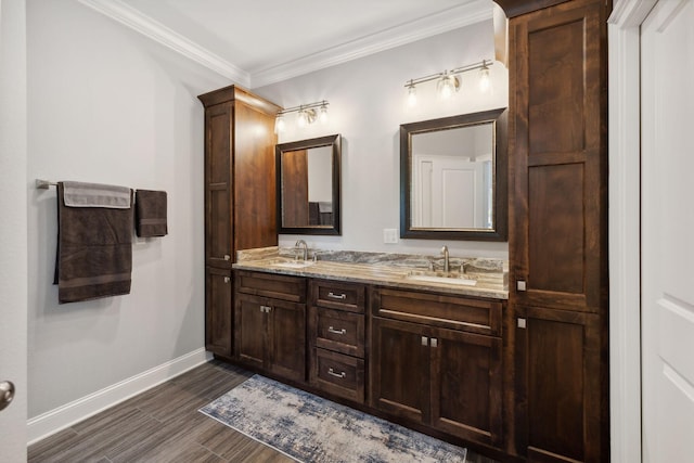 bathroom featuring hardwood / wood-style flooring, crown molding, and vanity