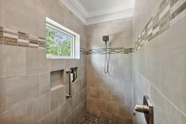 bathroom featuring ornamental molding and a tile shower