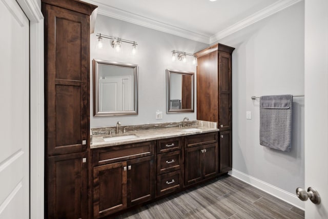 bathroom with crown molding, vanity, and hardwood / wood-style floors